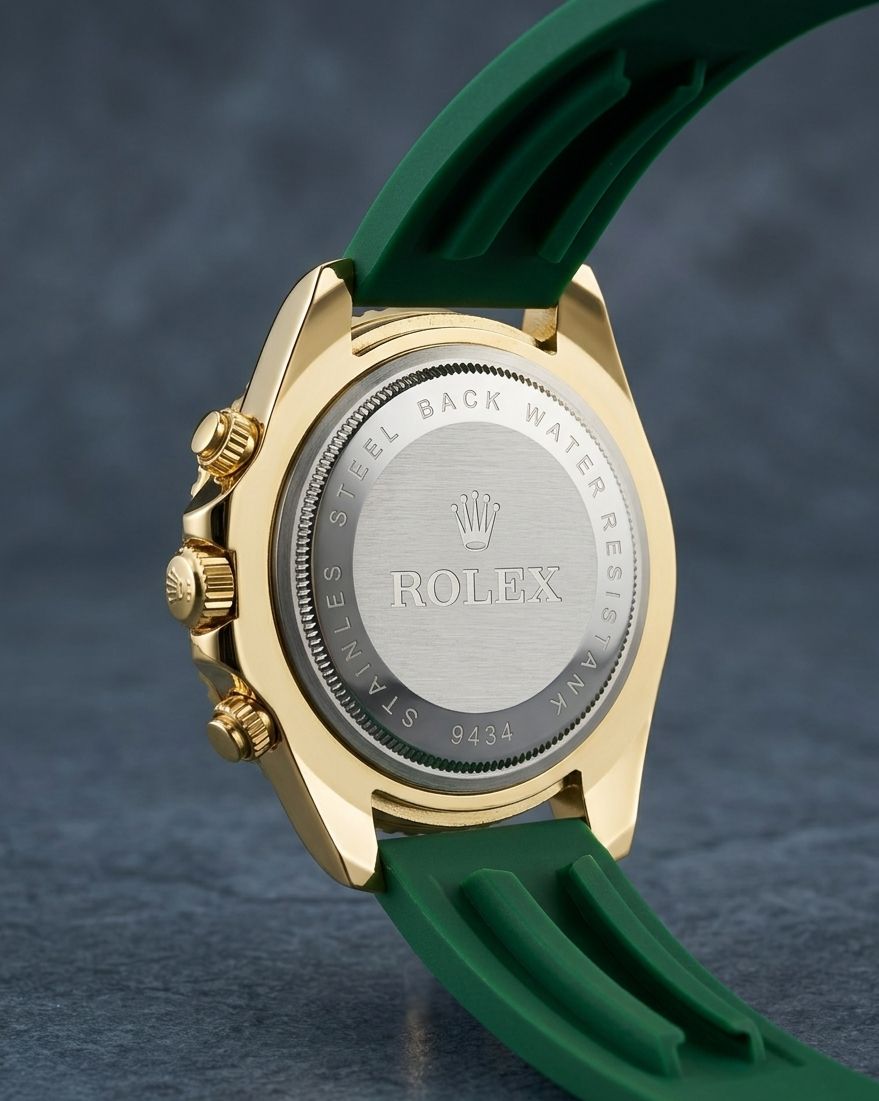 Rolex Submariner Date with a green dial, yellow gold case, and green rubber strap