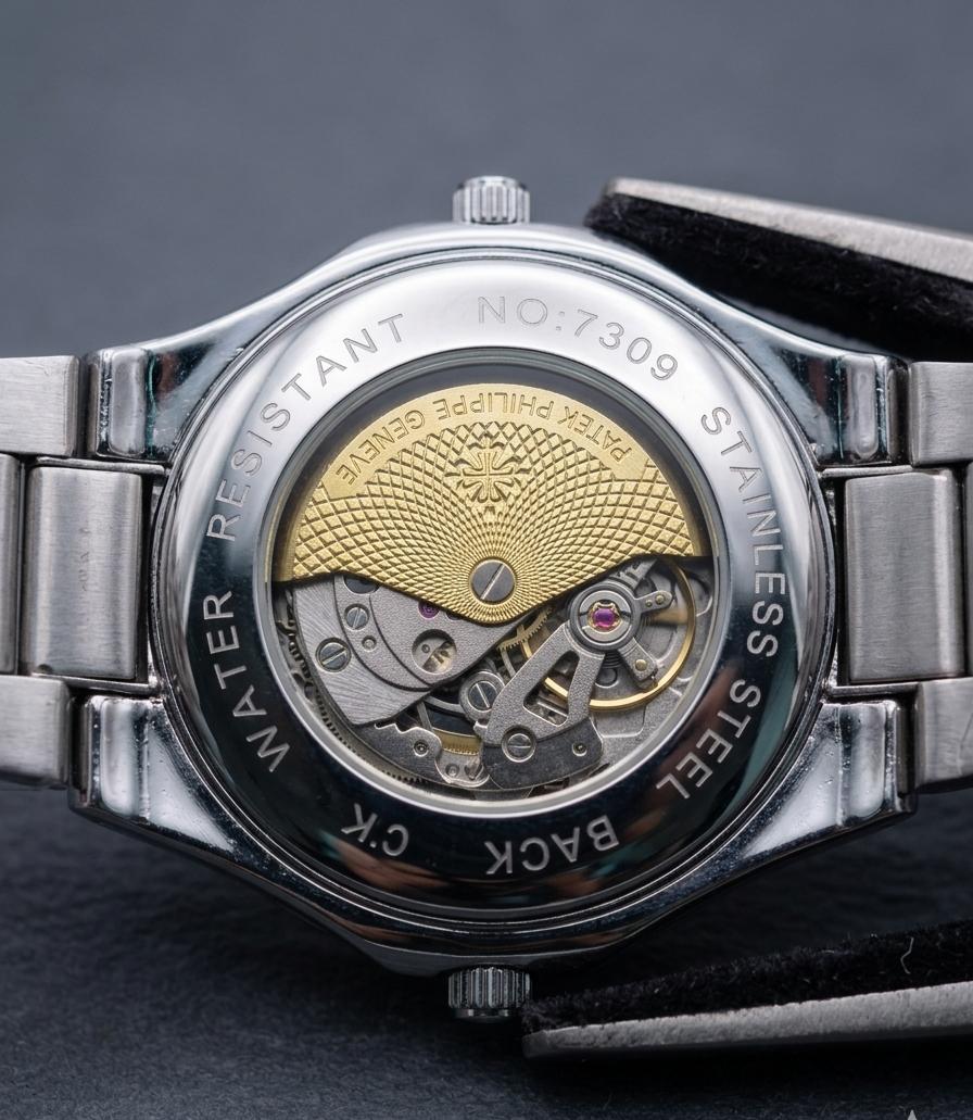 Patek Philippe watch featuring a distinctive turquoise dial and a mechanical movement visible through the dial