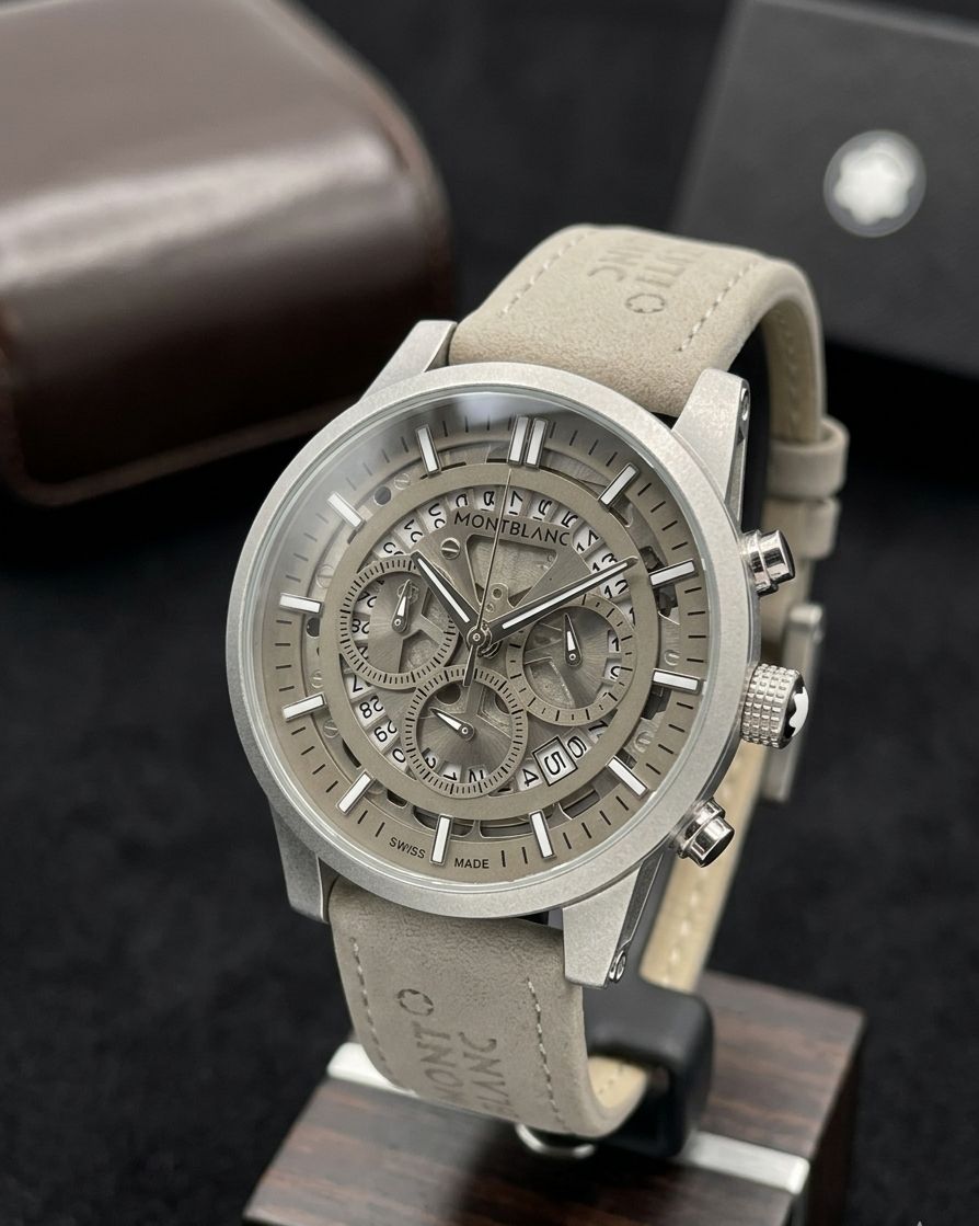 This Montblanc timepiece is a grey chronograph watch featuring a grey dial, luminous hands, and a grey suede leather strap