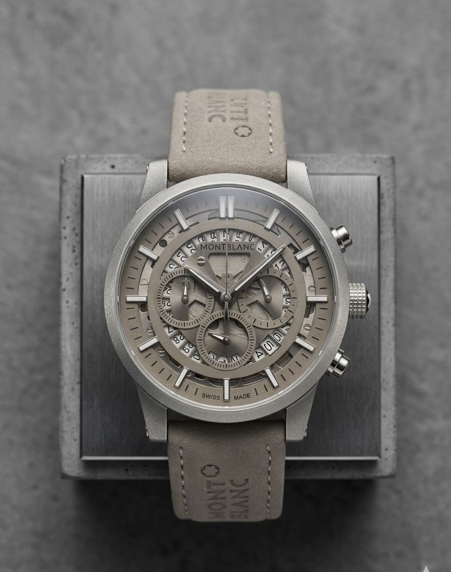 This Montblanc timepiece is a grey chronograph watch featuring a grey dial, luminous hands, and a grey suede leather strap